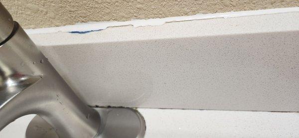 Mold around faucet by sink, painter tape prevents it from sticking? Isn't that how it seals.