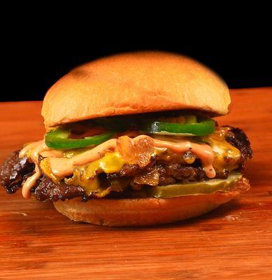 smash burger, jalapenos, sauce, grilled onions, roll, pickles