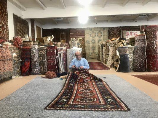 Area Rug Cleaning, Repair. Ali repairing an antique area rug.