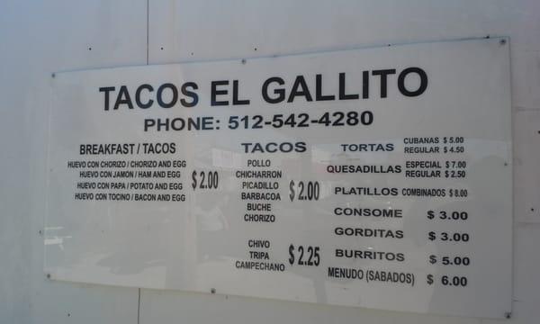 The menu for El Gallito.  100% Take-Out!  You buy your drinks at the Marshal Ford Food Mart directly behind you as you face the sign.