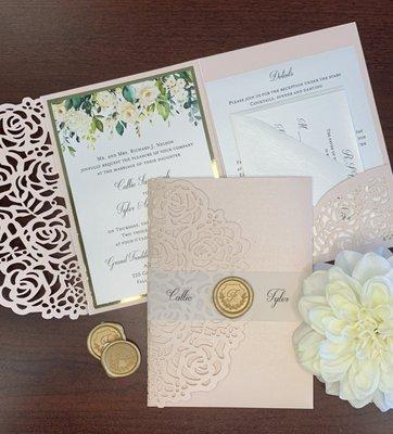 Blush laser cut invitation with vellum band and wax seal.