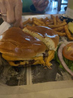 Lame burger and skimpy potion of fries in the background. The fries were good and hot.