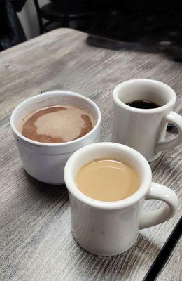 Giant mug of hot chocolate and some regular sized coffees