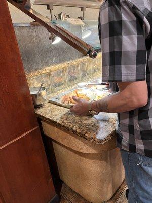 Guy loading this breaded shrimp