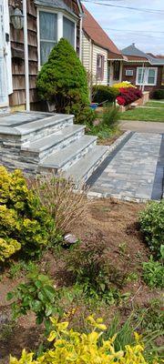 Granite stoop. Stone veneer riser steps and sides .Three piece random pattern Granite Cobblestone sides for flower box .