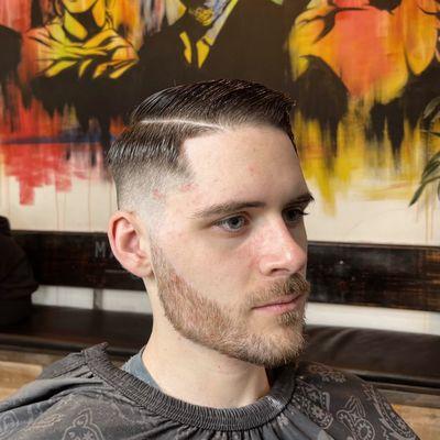 High Skin Fade w/ Part Comb Over and Beard Line up Done By @Barber.Esau (Instagram)