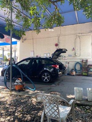 Car wash. Behind the chevron.