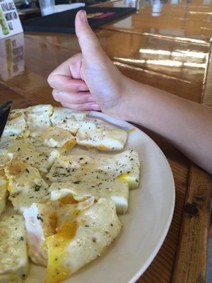 My daughter giving the over medium eggs a thumb up! :)