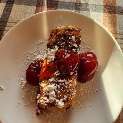 Cheesecake filled fried tortilla with cinnamon and sugar and strawberry drizzle.