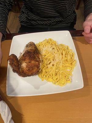 1/4 of a chicken and fettuccine pasta. Parmesan on top but the sauce was saffron not cheesy.