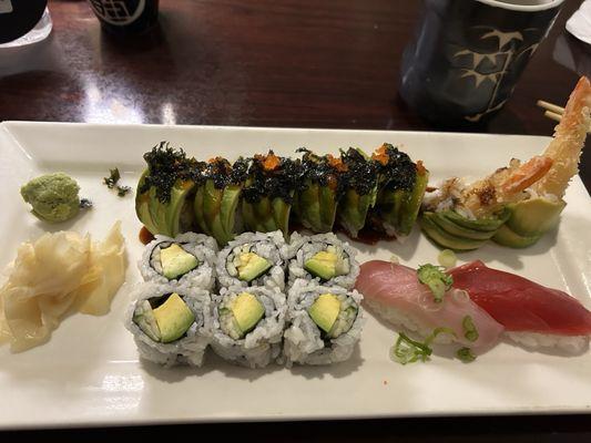 Yellowtail and tuna nigiri sushi, avocado and cucumber roll, and green dragon roll.