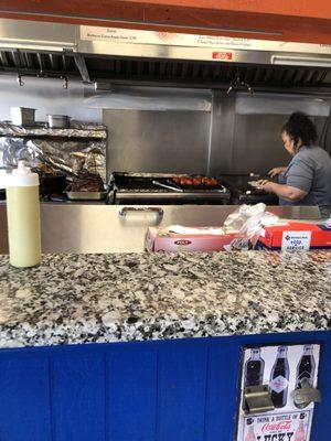 Nice woman who almost always cooks my food. Friendly smile!