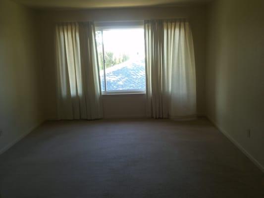 Large, double paned windows with drapes