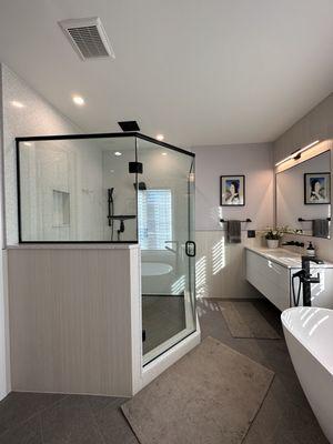 Custom shower with quartz walls, tile floor and recessed rain shower.