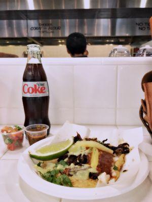 Diet Coke in a glass bottle, indulgence. Adobada taco $3.50.