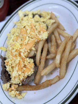 Bistec a Caballo with added cheese and side of fries.