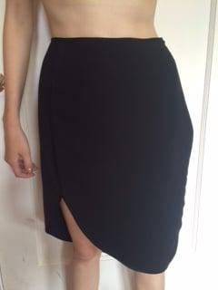 I am standing completely straight; the large lump on the right side of the skirt is created by an improperly reattached zipper.