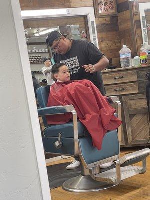 During his cut. Both these gentleman have done his hair so far and both are great