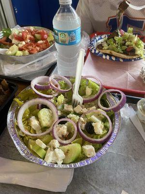 Two Greek salads, a side of gyro meat and a gyro