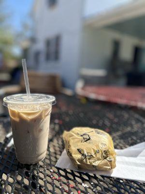 Ice chai latte with oat milk and an English muffin sandwich