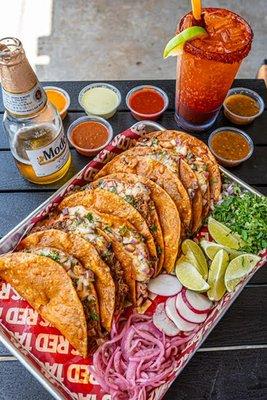 Birria tacos w/ cheese paired with our homemade signature salsas & ice cold michelada