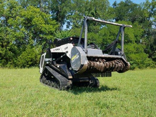 Clear Land Loftness tree and branch mulching skid steer attachment.