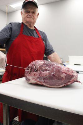 Man cutting beef.