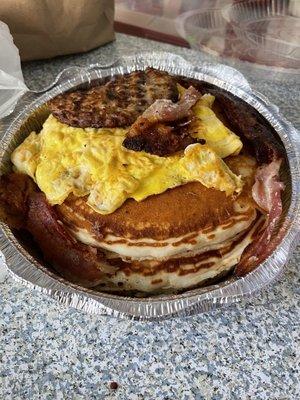 Pancakes, add egg, add bacon, add sausage. Huge portion enough for 2