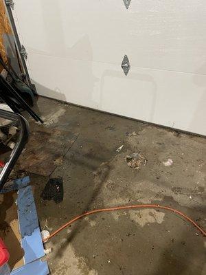 Water running out garage door