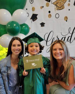 A happy graduate with his favorite teachers