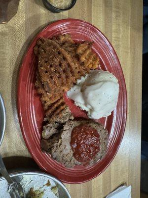 Meatloaf with sweet potatoes fries and a sauce that tastes like apple and pineapple to dip them in.