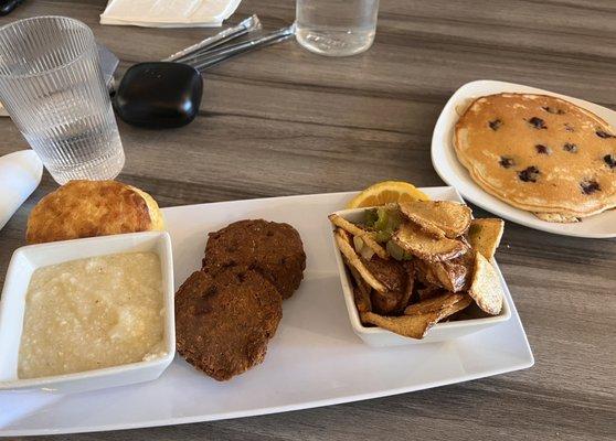 Salmon Croquettes, Grits, Home Fries, Blueberry Pancakes and a biscuit.