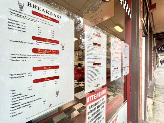 Breakfast menu (second page) on the front glass of cafe.