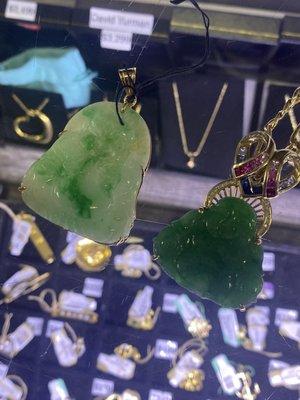 My pendant is the jade one on the right with the heart worth (3k) with rubies sapphires and diamonds. There's is the fake one on the left.