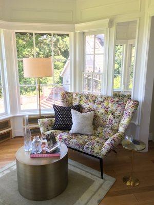 A sunny seating area we recently staged for Christie's Realty, featuring the lively Tuulla Loveseat.