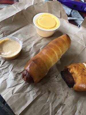 Pup (hot dog) and brisket pretzel with small cheese and white sauce from Sugar Fire