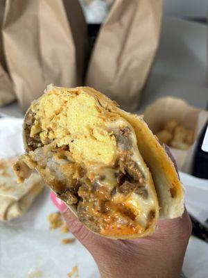 The Wurst Burrito (sausage, egg, tater tots, caramelized onions, spicy mayo)