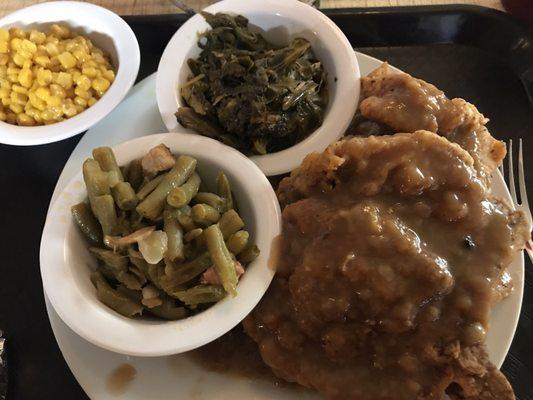 Smothered Pork Chop & Chicken with Collared Greens, Green Beans, Corn, and a Cornbread Muffin.