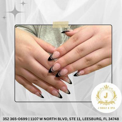 Elegant and sleek black and nude abstract nail design, perfect for making a bold yet sophisticated statement.