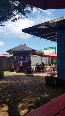 Sushi food cart and some seating.