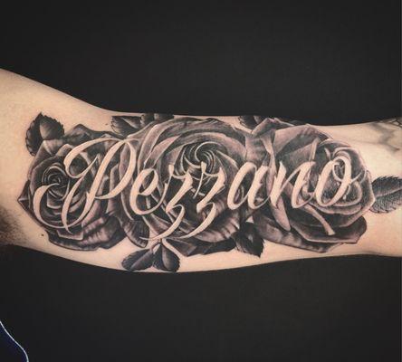 Black and grey rose tattoo done by Oksana Weber