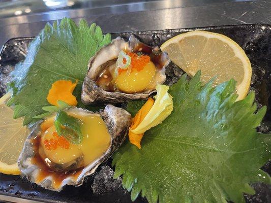 Oyster toped with quail egg and served with Ponzu sauce.