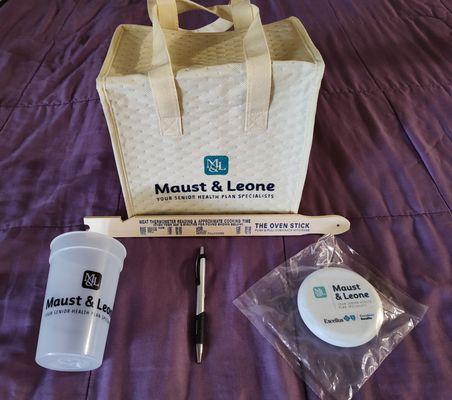 Gifts: Tote bag cooler, Oven stick, Pizza cutter, Water glass, Pen.