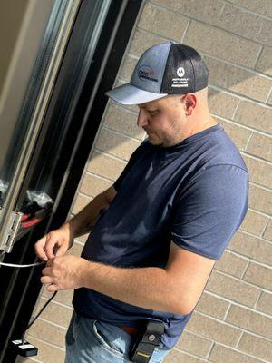 Technician installing Door Access Control in a government building.