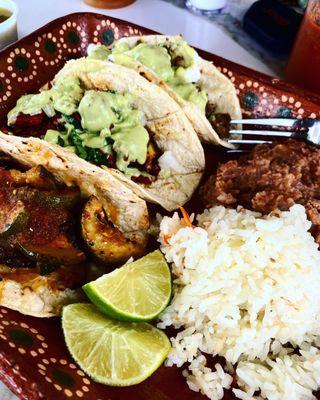 Vegetarian, Al Pastor and Bison tacos with rice, beans and green chile