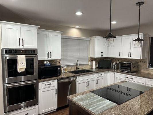 Overall view on main kitchen area with contrasting darker color island