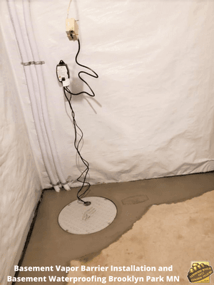 Vapor Barrier on walls, with new cement over new drain tile.  Custom sump pump lid with dual discharge