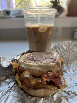 Bacon egg and cheese on an English muffin and an iced coffee