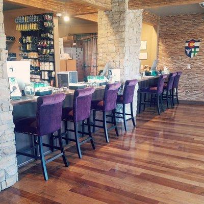 Our lovely wooden floor, stone pillars, and beautiful purple velvet chairs for you to rest your wares!