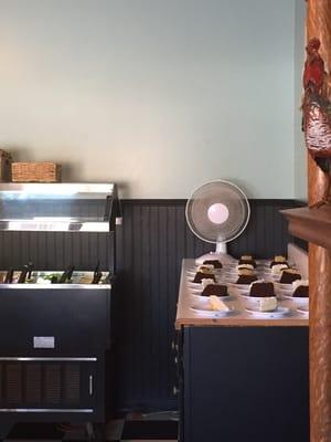 Dirty fan blowing over food. Oscillating fan blowing over uncovered cake and salad bar.